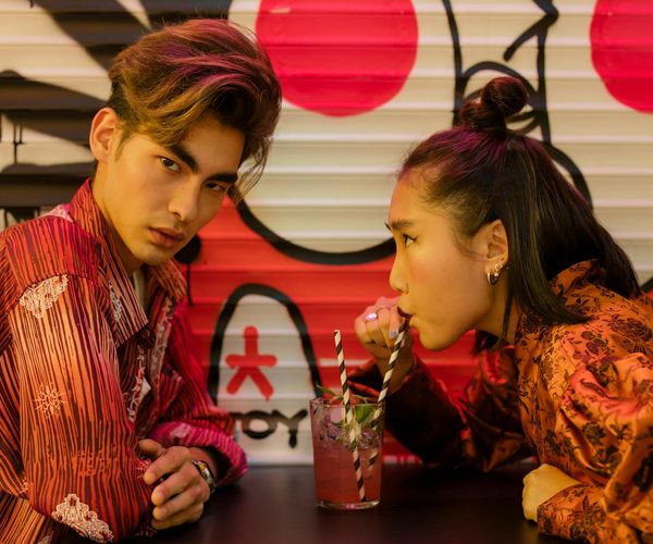 A person calmly sipping tea looking out a window.